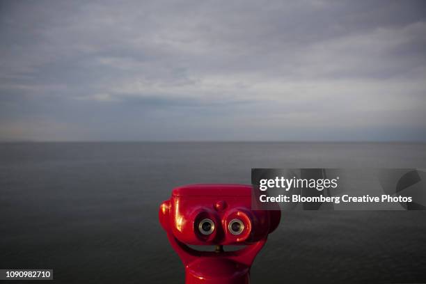 coin operated binoculars look out over the baltic sea - coin operated binocular nobody stock pictures, royalty-free photos & images