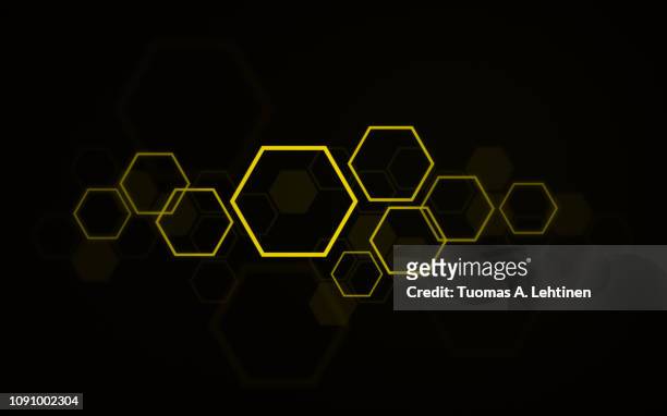 yellow hexagons on black background - bienenwabe stock-fotos und bilder