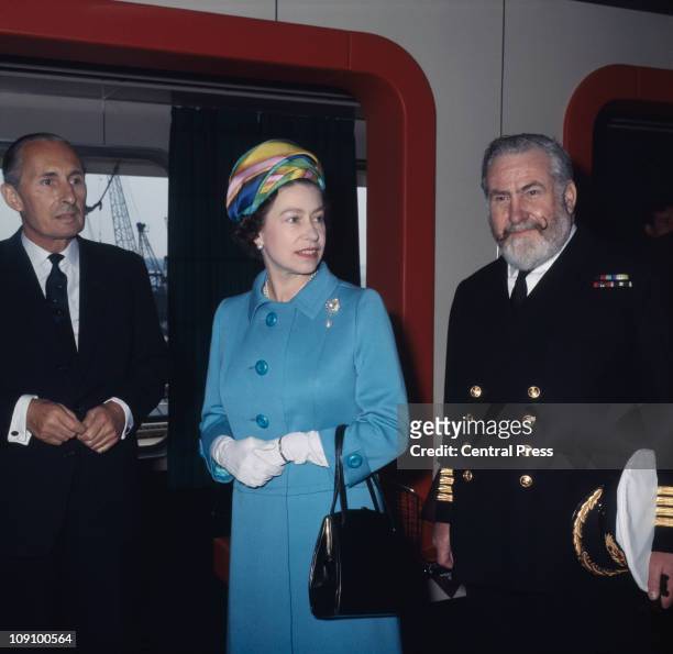 Queen Elizabeth II is shown around the new Cunard liner 'RMS Queen Elizabeth 2' or 'QE2' at Southampton by Commodore William Warwick and Cunard...