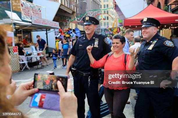 visitor and police at feast of san gennaro festival - san gennaro festival stock pictures, royalty-free photos & images