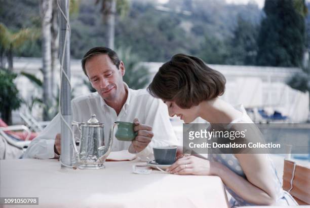 Actress Audrey Hepburn and husband actor Mel Ferrer pose for a photo at the Bel Air Hotel on March 27, 1957 in Los Angeles, California.