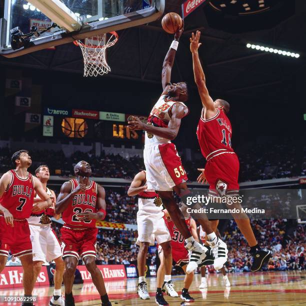 Dikembe Mutombo of the Atlanta Hawks dunks the ball against the Chicago Bulls on May 10, 1997 during Game Two of the NBA Eastern Conference...