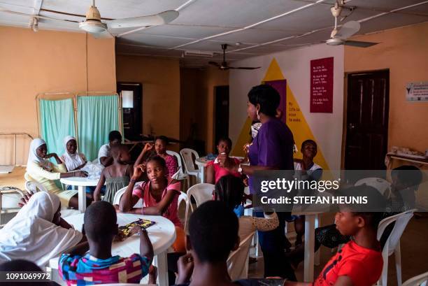 Young girls listen to an educational talk about puberty at the Bada Primary Health Centre in Lagos on November 11, 2018. - The "9ja Girls" is a...