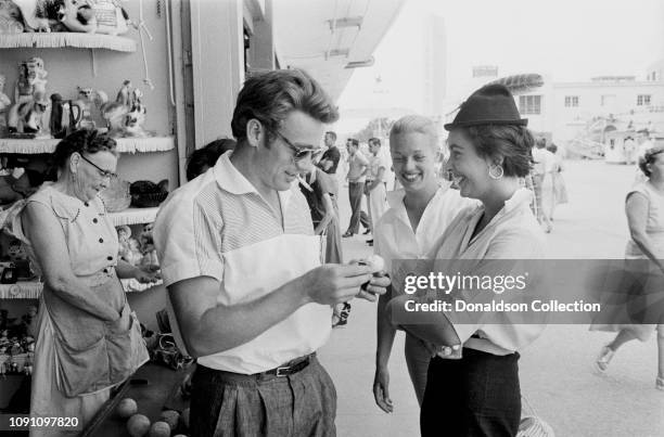 Actor James Dean, hair stylist Pat Westmore and actress Elizabeth Tayor attend the Texas State Fairgrounds on a weekend break during the filming of...