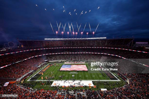 Singer Andy Grammer performs the national anthem as the American flag waves on the field prior to the College Football Playoff National Championship...
