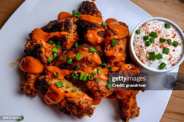 plate of buffalo chicken wings with ranch dressing - ranch dressing stock pictures, royalty-free photos & images