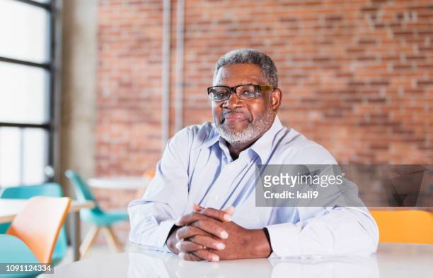 senior african-american businessman, hands clasped - 60 64 years stock pictures, royalty-free photos & images