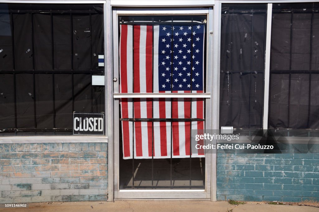 Abandoned building and American flag behind the door at Paris, Texas, USA