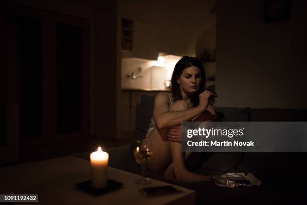 unhappy woman feeling low, having chocolate. - low alcohol drink stock pictures, royalty-free photos & images