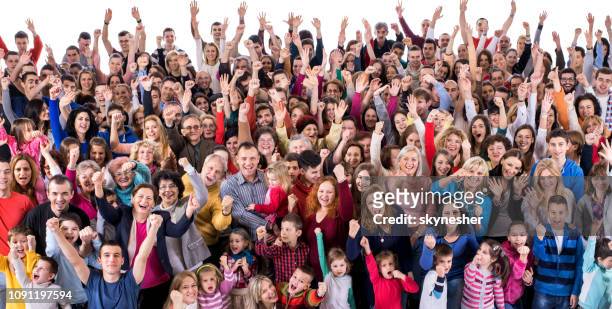 crowd of excited people celebrating with raised hands. - crowd cheering stock pictures, royalty-free photos & images