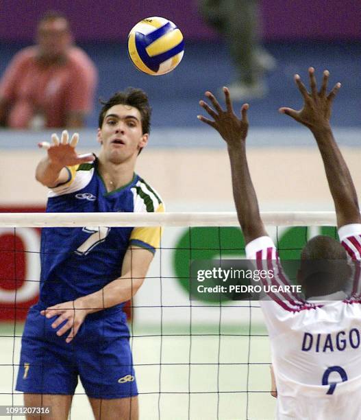 Gilberto Godoy of Brazil spikes the ball as Raul Diago of Cuba attempts to block during their XIII Pan Am Games Men's Volleyball gold medal match 02...