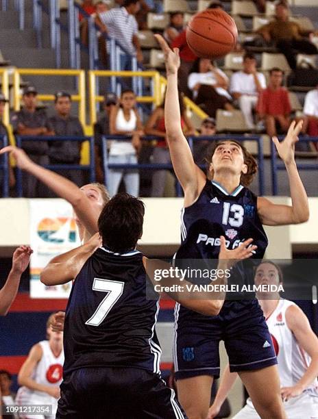 Gisella Vega of Argentina grabs the ball near teammate Iris Ferazzoli and Canadian Michele Hendry 14 September 2001 in Sao Luis do Maranhao, Brazil....