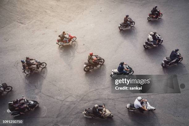 aerial view of a traffic in hanoi, vietnam - motorcycle group stock pictures, royalty-free photos & images