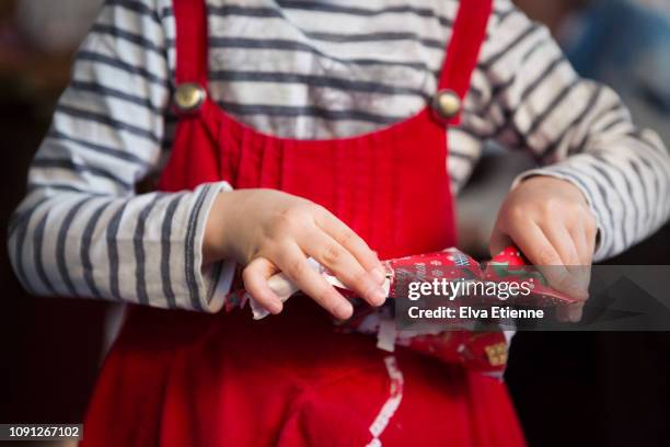 midsection of child opening small christmas present - open day 6 stock pictures, royalty-free photos & images