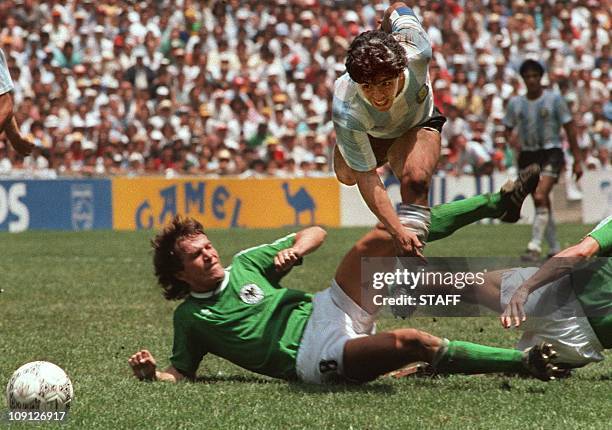 Argentina's soccer star team captain Diego Maradona evades a tackle from West Germany's Lothar Matthaus during the World Soccer Cup final, won by...