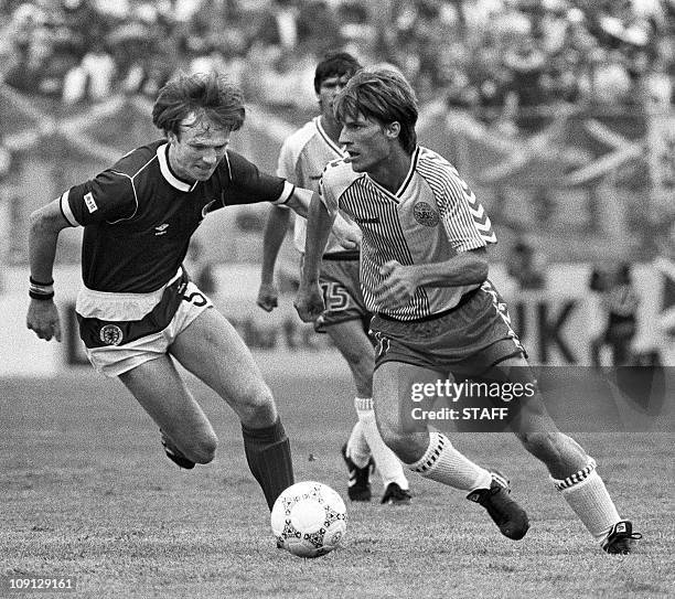 Danish forward Michael Laudrup tries to dribble by Scottish Alex McLeish during the World Cup first round soccer match between Denmark and Scotland...