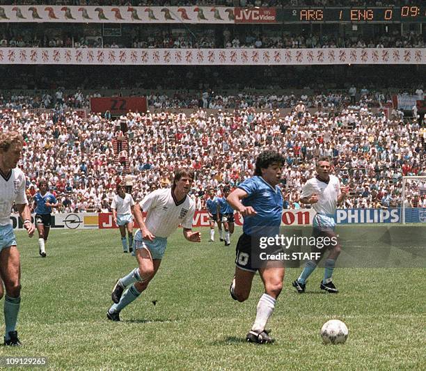 Argentinian forward Diego Armando Maradona runs past English defenders Terry Butcher and Terry Fenwick on his way to scoring his second goal during...