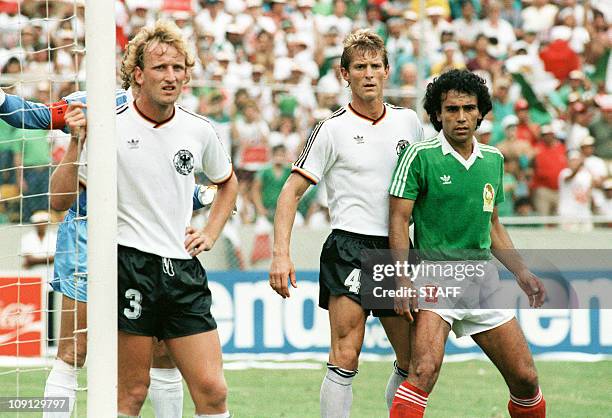 Mexican forward Hugo Sanchez , standing near the goal cage, waits for a corner kick surrounded by West German defenders Andreas Brehme and Karlheinz...