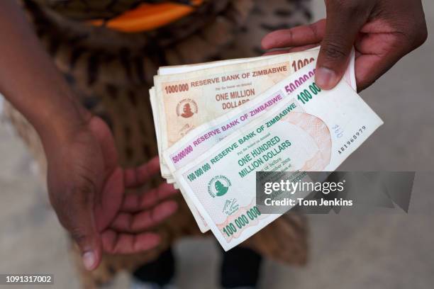 Matabeleland fan selling Zimbabwean dollars in order to raise money during their 5-0 loss to Szekely Land in the Conifa World Football Cup 2018 at...