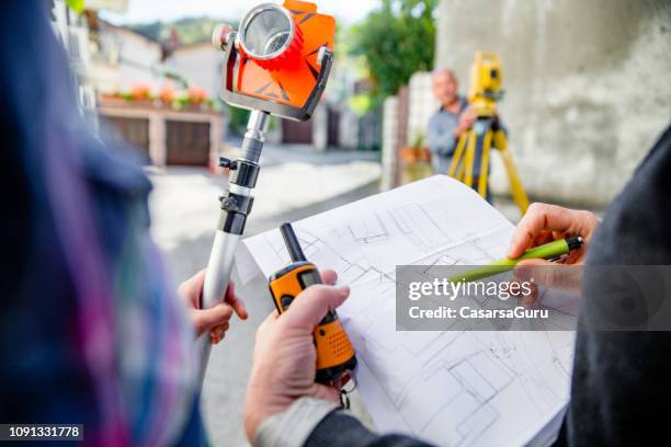 female surveyors looking at map on city street - surveyor stock pictures, royalty-free photos & images