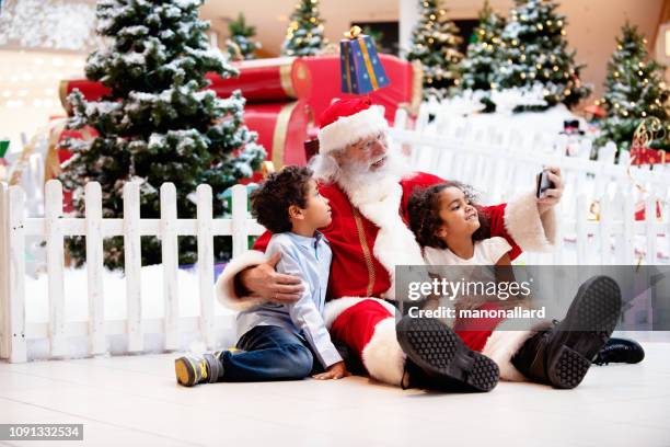 shopping christmas with family and santa claus at shopping mall - heritage shopping centre stock pictures, royalty-free photos & images