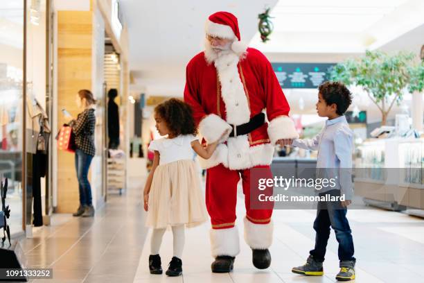 shopping christmas with family and santa claus at shopping mall - heritage shopping centre stock pictures, royalty-free photos & images