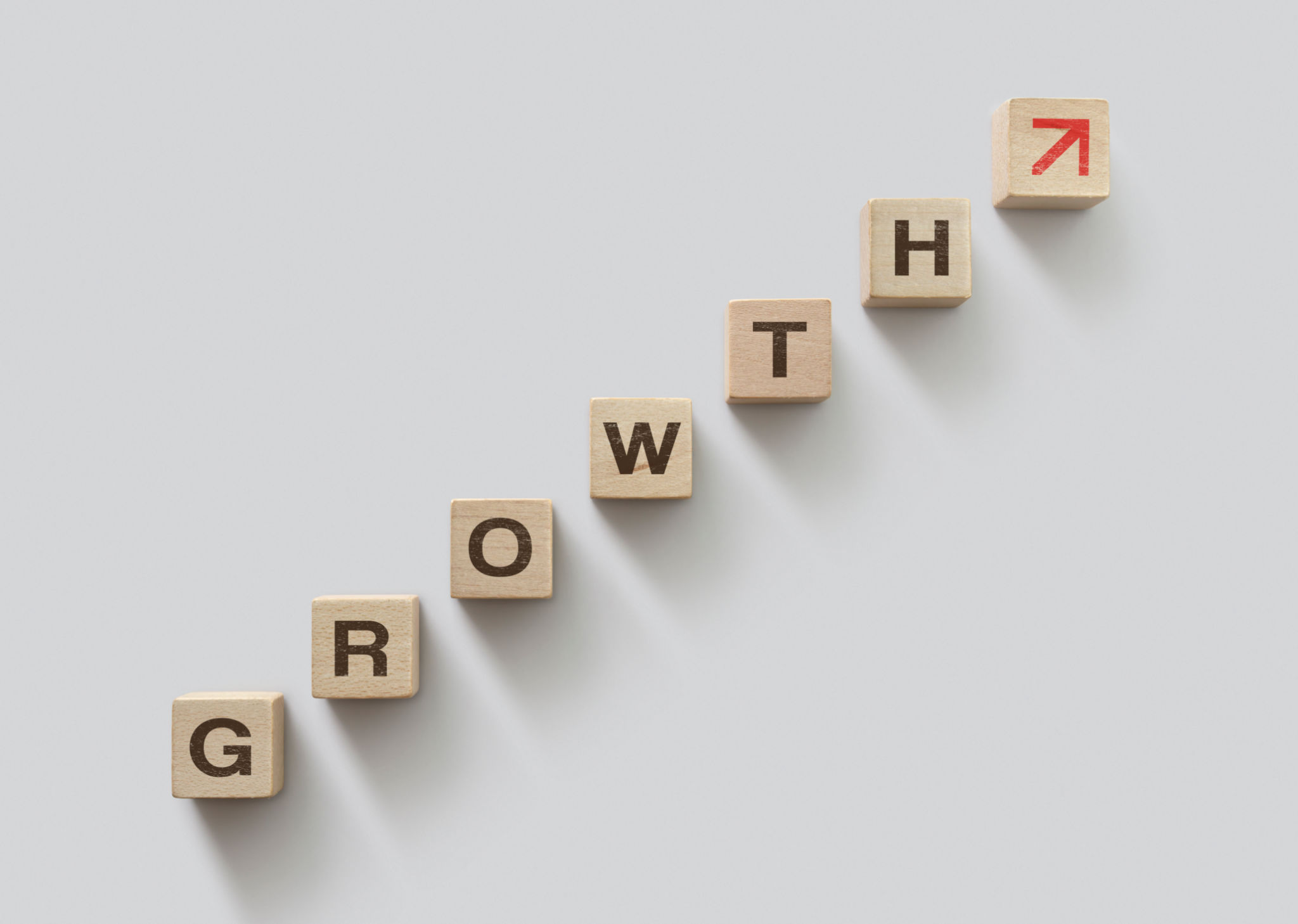 Wooden blocks arranged in stair shape with the word GROWTH. Business growth, career growth or growth concept. Wooden blocks arranged in stair shape with the word GROWTH. Business growth, career growth or growth concept.