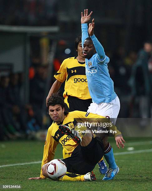 Juan Carlos Toja of Aris and Shaun Wright-Phillips of Machester City in action during the first leg, round of 32 UEFA Europa League match between...