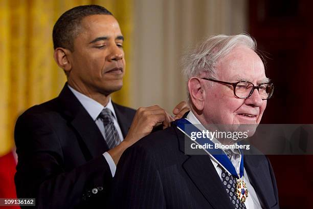 President Barack Obama, left, awards the Presidential Medal of Freedom to Warren Buffett, chairman and chief executive officer of Berkshire Hathaway...