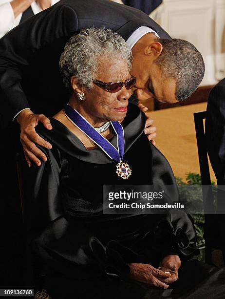 President Barack Obama kisses poet and author Maya Angelou after giving her the 2010 Medal of Freedom in the East Room of the White House February...