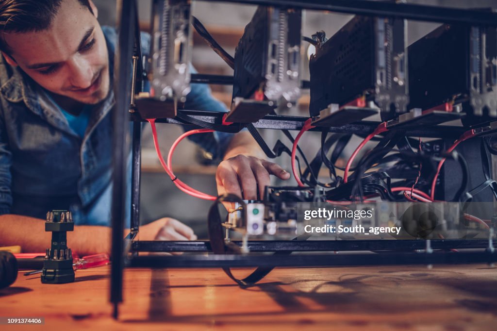 Mining Machine Computer Guy Configures Computer Equipment For Mining Cryptocurrency High-Res ...