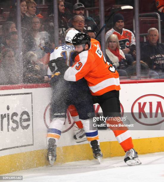 Radko Gudas of the Philadelphia Flyers checks Brayden Schenn of the St. Louis Blues at the Wells Fargo Center on January 07, 2019 in Philadelphia,...