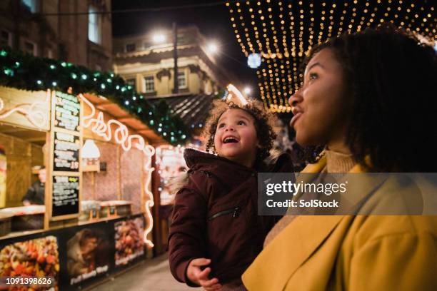 looking at christmas lights in awe - christmas market uk stock pictures, royalty-free photos & images
