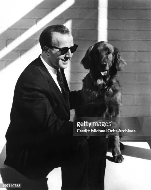 English jazz pianist George Shearing poses for a portrait with his dog circa 1965 in Los Angeles, California.