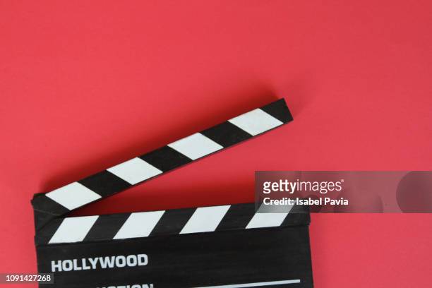 filmmaker's clapboard on red background. - film grain stock pictures, royalty-free photos & images