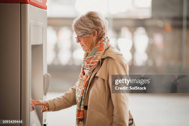 collecting a train ticket - ticket machine stock pictures, royalty-free photos & images