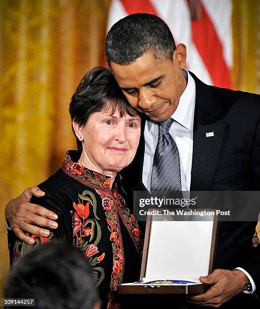 Washington, DC President Barack Obama embraces Libby Little, who grew misty as her late father, Dr. Tom Little's accomplishments were announced...