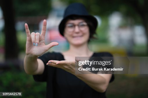 Sign Showing Young Woman Showing A Sign High-Res Stock Photo - Getty Images
