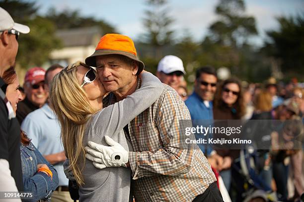 Pebble Beach National Pro-Am: Celebrity actor Bill Murray receiving kiss from fan in gallery during Sunday play at Pebble Beach Golf Links.Pebble...