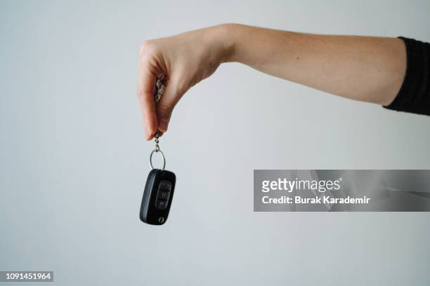 woman holding car key, close-up - finger studio close up stock-fotos und bilder