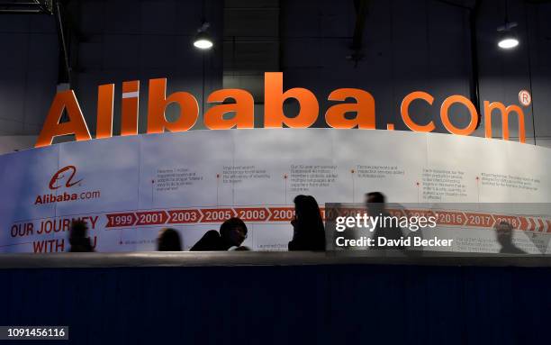 Attendees pass by an Alibaba.com display at CES 2019 at the Las Vegas Convention Center on January 8, 2019 in Las Vegas, Nevada. CES, the world's...