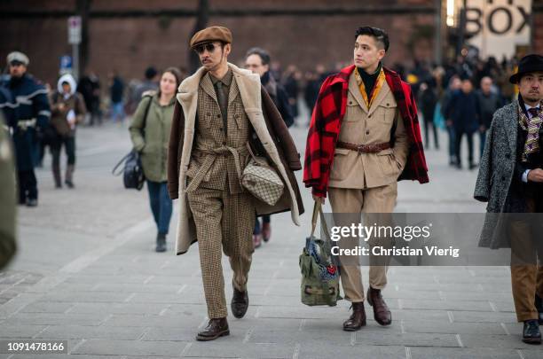 Guest is seen wearing flat cap, beige suit, shearling jacket during the 95th Pitti Uomo at Fortezza Da Basso on January 08, 2019 in Florence, Italy.