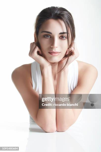 portrait of beautiful brunette woman with clean face 5 - hand on chin stock pictures, royalty-free photos & images