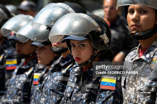 Members of the Bolivarian National Police stand guard near "Dr. JM de los Rios" Children's Hospital in Caracas, during a protest against the...