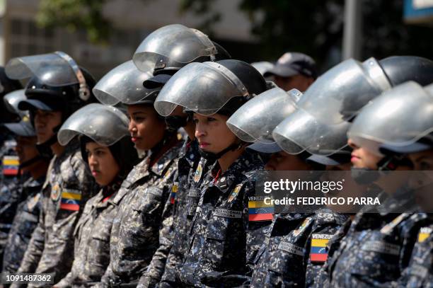 Members of the Bolivarian National Police stand guard near "Dr. JM de los Rios" Children's Hospital in Caracas, during a protest against the...