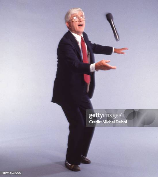 View of American television personality Phil Donahue as he tosses a microphone in the air, New York, New York, May 19, 1992. This photo was taken as...