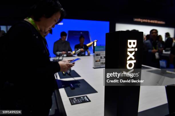 Attendees examine Bixby enabled devices at the Samsung booth during CES 2019 at the Las Vegas Convention Center on January 8, 2019 in Las Vegas,...