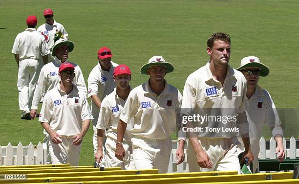 South Australian fast bowler Mark Harrity leads his team from the field after taking 4 for 51 in the Pura Milk Cup match between the South Australian...