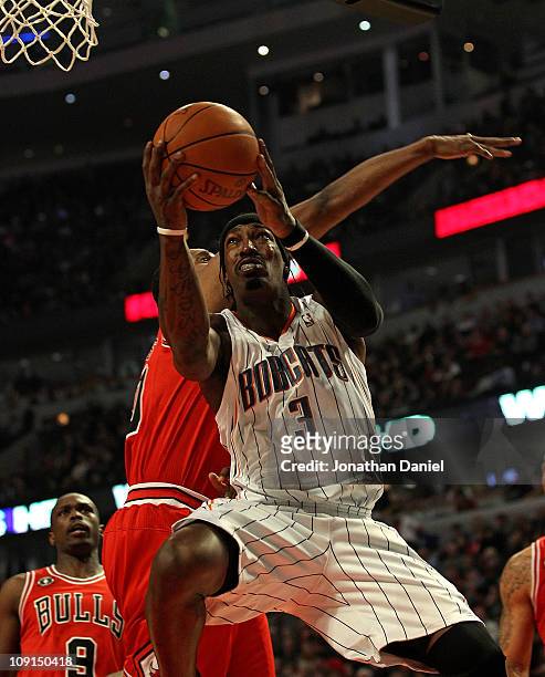 Gerald Wallace of the Charlotte Bobcats goes up for a shot past Kurt Thomas of the Chicago Bulls at the United Center on February 15, 2011 in...