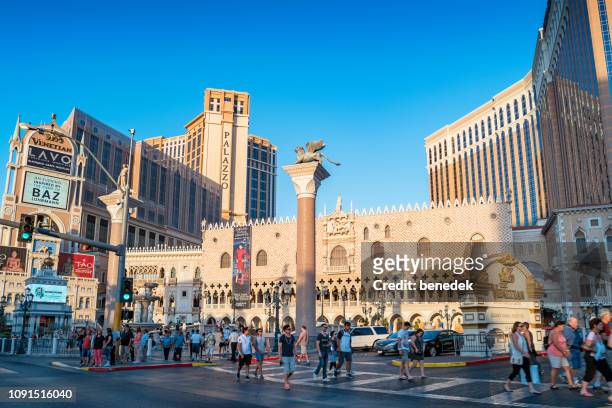 pedestrians cross street at the venetian casino in las vegas nevada usa - nevada stock pictures, royalty-free photos & images